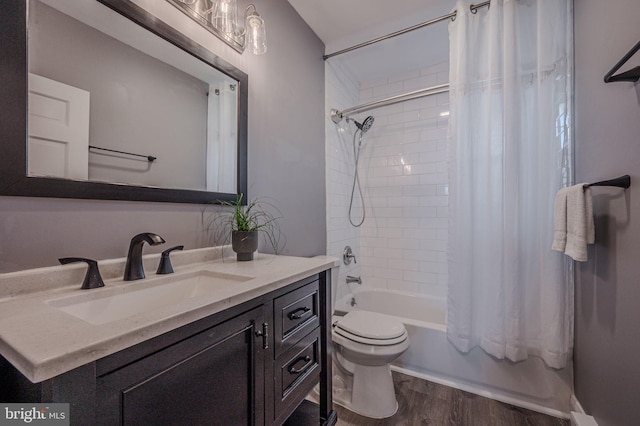 bathroom with shower / bath combo, toilet, vanity, and wood finished floors