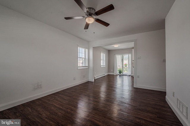 unfurnished room featuring baseboards, a ceiling fan, dark wood-type flooring, visible vents, and a baseboard radiator
