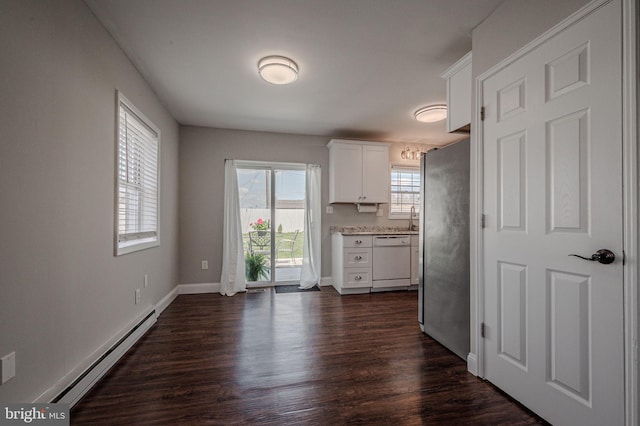 kitchen featuring freestanding refrigerator, dark wood-type flooring, white cabinets, baseboard heating, and white dishwasher