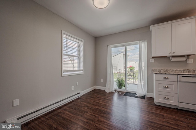 unfurnished dining area featuring dark wood finished floors, a baseboard radiator, baseboards, and a healthy amount of sunlight