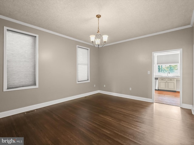 13 N Allegany St, Cumberland, MD 21502 - empty room featuring a chandelier, dark wood finished floors, a textured ceiling, ornamental molding, and baseboards