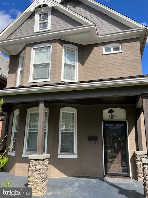 13 N Allegany St, Cumberland, MD 21502 - property entrance with covered porch and brick siding