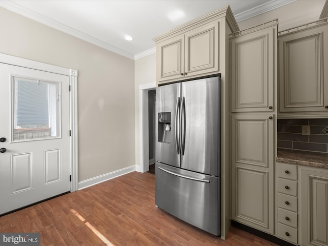 13 N Allegany St, Cumberland, MD 21502 - kitchen with stainless steel fridge, cream cabinets, crown molding, baseboards, and backsplash
