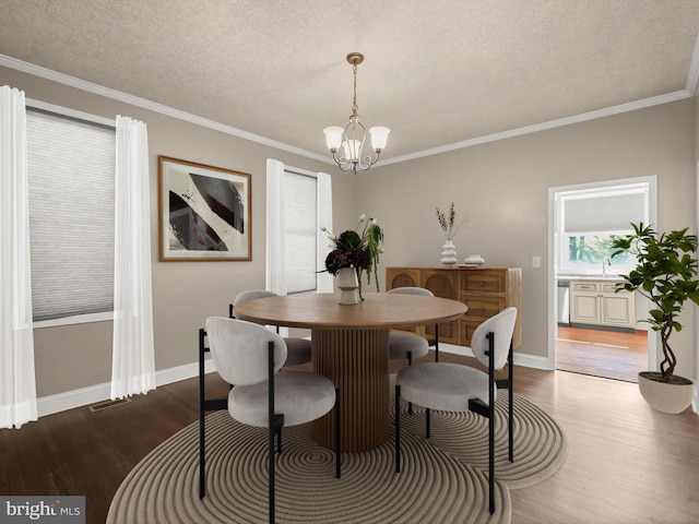 13 N Allegany St, Cumberland, MD 21502 - dining room with a chandelier, wood finished floors, crown molding, baseboards, and a textured ceiling