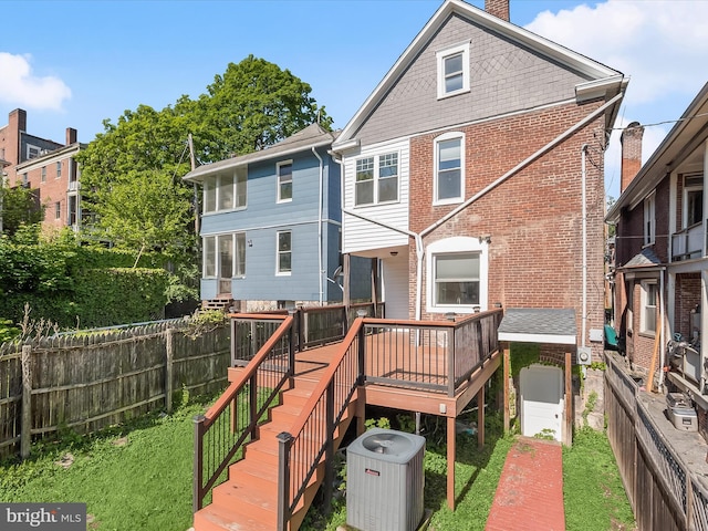 13 N Allegany St, Cumberland, MD 21502 - rear view of property with central AC, a deck, fence, brick siding, and a chimney