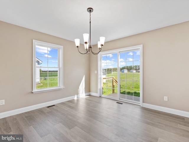 200 School Rd, Bethel, DE 19931 - spare room featuring a notable chandelier, visible vents, baseboards, and wood finished floors