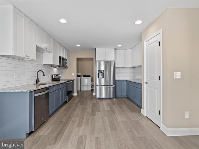 200 School Rd, Bethel, DE 19931 - kitchen featuring independent washer and dryer, a sink, white cabinetry, and appliances with stainless steel finishes