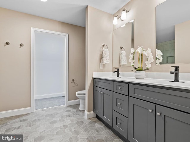 200 School Rd, Bethel, DE 19931 - bathroom with double vanity, baseboards, a sink, and toilet