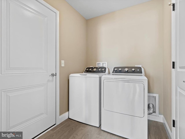 200 School Rd, Bethel, DE 19931 - washroom featuring laundry area, separate washer and dryer, wood finished floors, and baseboards