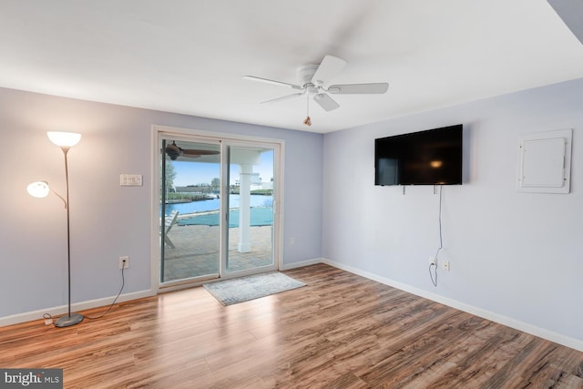 33 W Delaware Dr, Little Egg Harbor Twp, NJ 08087 - unfurnished living room featuring baseboards, a ceiling fan, wood finished floors, and electric panel