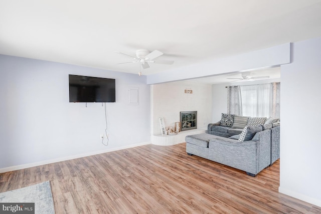 33 W Delaware Dr, Little Egg Harbor Twp, NJ 08087 - living room with ceiling fan, wood finished floors, and a fireplace