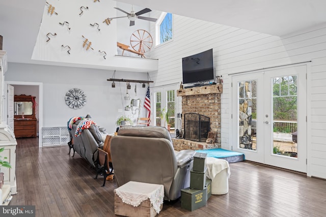 173 Puffball Rd, Hedgesville, WV 25427 - living area featuring a brick fireplace, a ceiling fan, wood-type flooring, a towering ceiling, and french doors
