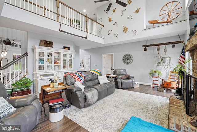 173 Puffball Rd, Hedgesville, WV 25427 - living area with stairs, wood-type flooring, a towering ceiling, and a ceiling fan