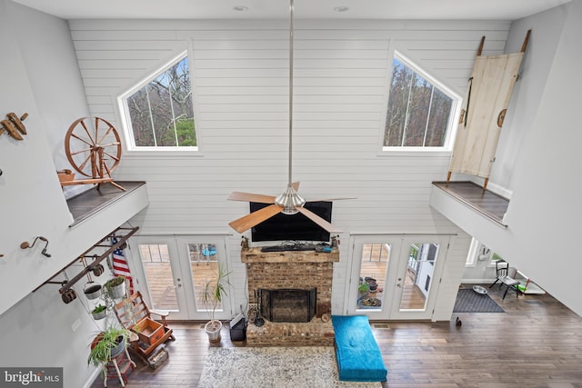 173 Puffball Rd, Hedgesville, WV 25427 - living area with wood walls, wood-type flooring, and french doors