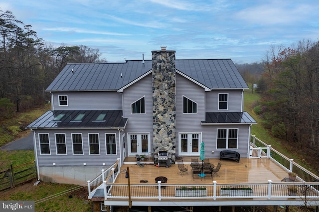 173 Puffball Rd, Hedgesville, WV 25427 - back of property featuring a chimney, french doors, outdoor dining area, a standing seam roof, and metal roof