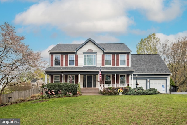 colonial-style house with a porch, an attached garage, fence, and a front yard