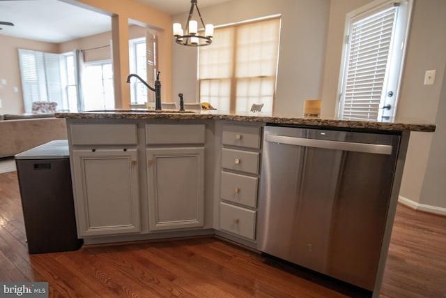 12253 Tulane Falls Dr, Bristow, VA 20136 - kitchen with open floor plan, a notable chandelier, stainless steel dishwasher, and dark wood-style flooring