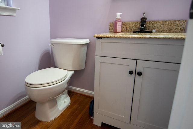 12253 Tulane Falls Dr, Bristow, VA 20136 - half bathroom with baseboards, toilet, vanity, and wood finished floors