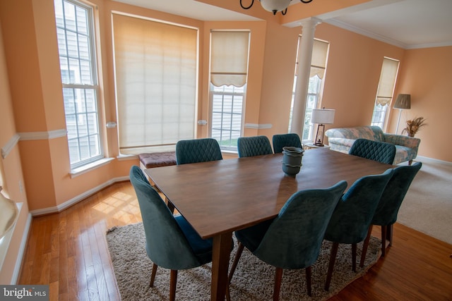 12253 Tulane Falls Dr, Bristow, VA 20136 - dining area featuring baseboards, ornamental molding, wood finished floors, and ornate columns