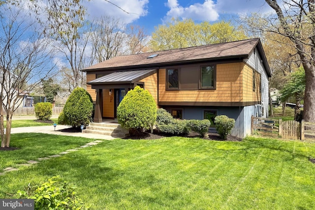 view of front of house with a front lawn and fence