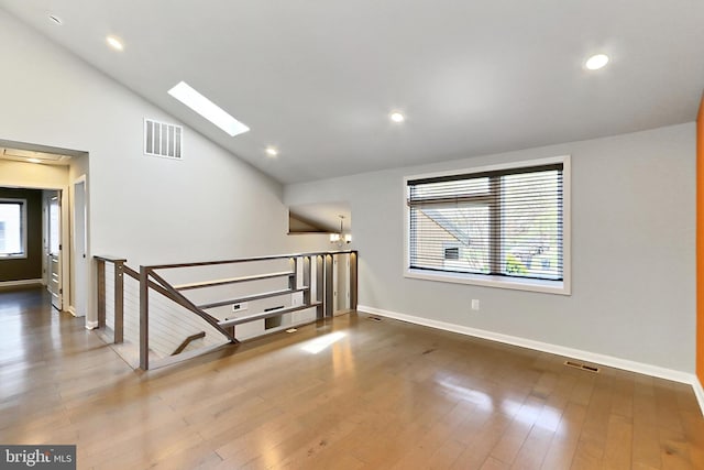 bonus room with visible vents, baseboards, and lofted ceiling with skylight
