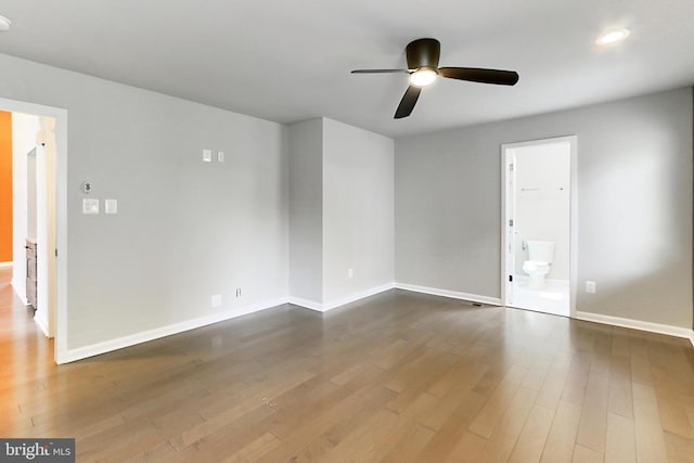 spare room with wood finished floors, baseboards, a ceiling fan, and recessed lighting