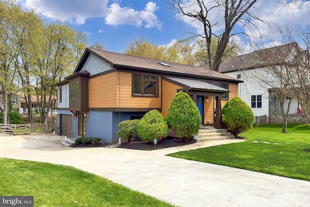 view of front of property with driveway, a garage, fence, and a front lawn