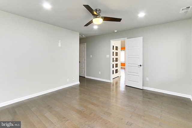 unfurnished room featuring ceiling fan, visible vents, recessed lighting, wood finished floors, and baseboards