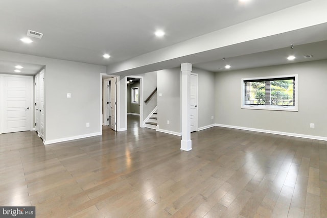 below grade area featuring wood finished floors, recessed lighting, baseboards, and stairway