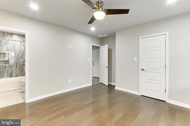 unfurnished bedroom with baseboards and wood finished floors