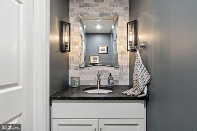 bathroom featuring vanity and decorative backsplash