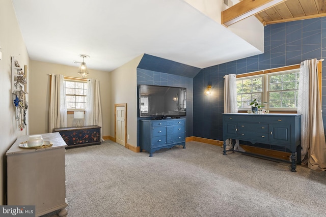 bedroom featuring baseboards, light colored carpet, and vaulted ceiling