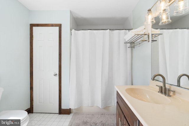 bathroom with toilet, tile patterned floors, and vanity