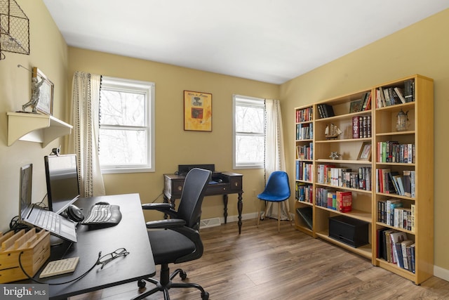 office with wood finished floors, baseboards, and visible vents
