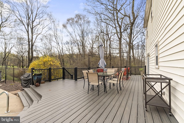 wooden terrace featuring outdoor dining area