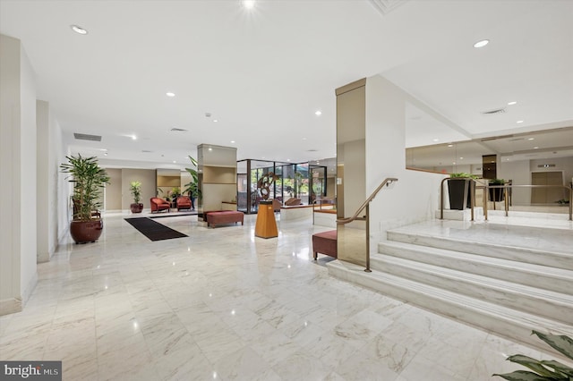 building lobby featuring recessed lighting and stairway