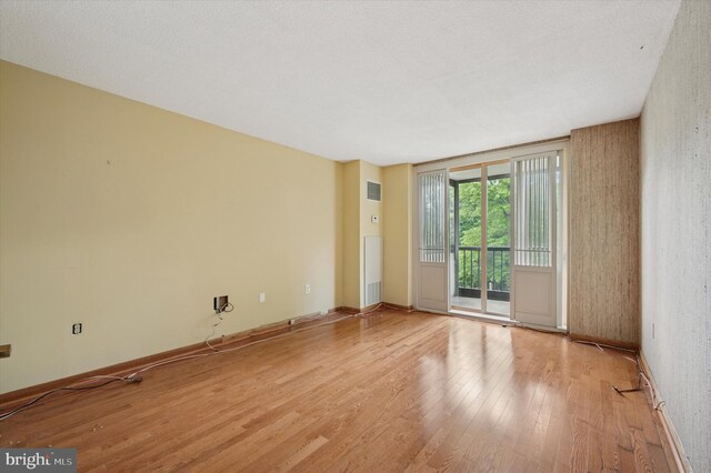 spare room featuring light wood-style flooring and baseboards