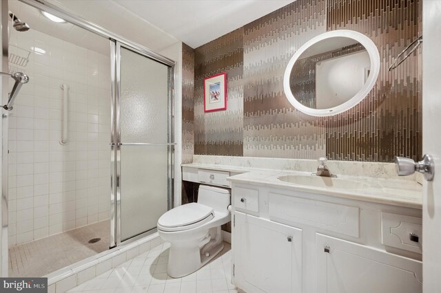 full bath with tile patterned floors, a shower stall, toilet, and vanity