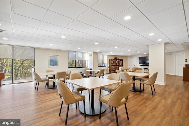 dining space with light wood-style floors and recessed lighting