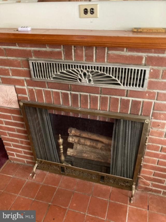 details featuring a brick fireplace