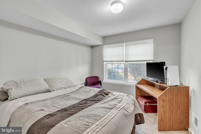 bedroom with visible vents and carpet