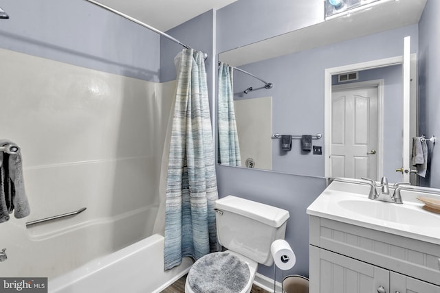 bathroom with shower / tub combo, vanity, visible vents, and toilet