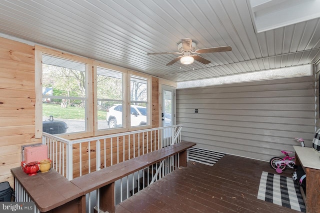 sunroom featuring a ceiling fan