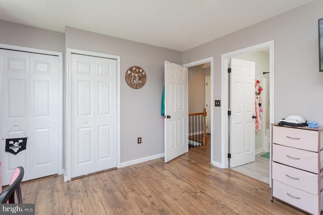 bedroom featuring baseboards and light wood-style floors