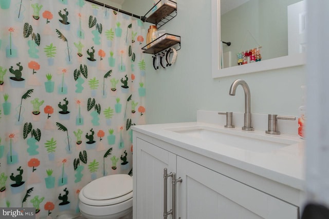 bathroom with toilet, vanity, and a shower with shower curtain