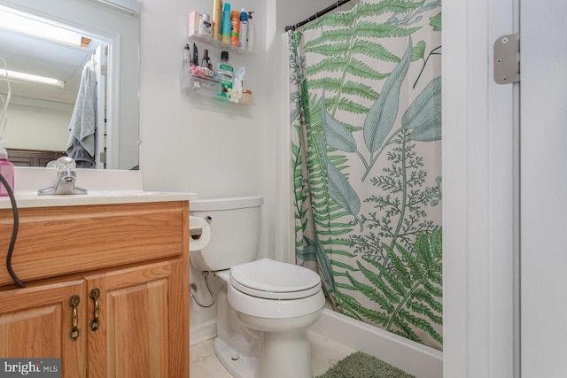bathroom with toilet, tile patterned floors, vanity, and curtained shower