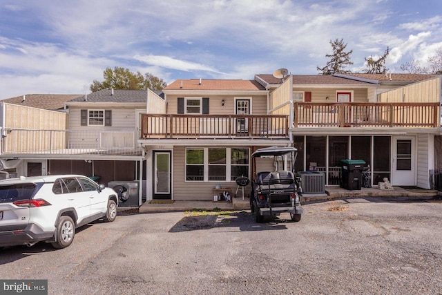 rear view of property with a balcony and cooling unit