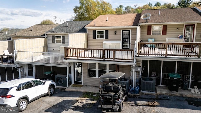 back of property featuring a balcony and central air condition unit