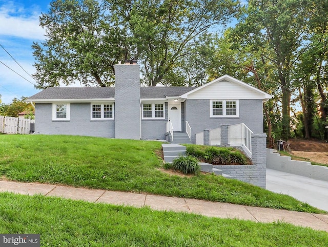 3407 29th Ave, Temple Hills, MD 20748 - ranch-style house featuring a chimney, a front yard, fence, and brick siding