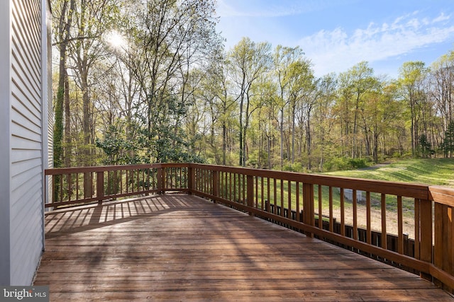 wooden deck featuring a forest view